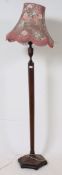 A good 1930's Art Deco oak standard lamp of hexagonal form complete with shade.