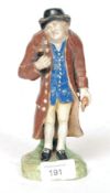 An early 19th century Staffordshire figure of an old gentleman,