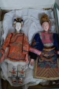 A pair of early 20th century Chinese male and female dolls dressed in full court regalia being