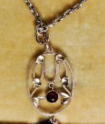 A 9ct gold gold box chain and ruby garnet stone pendant, circa early 20th century Art Nouveau.