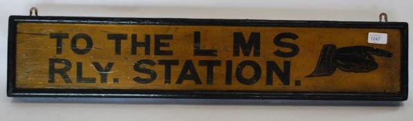 A vintage wooden painted railway sign with notation for LMS - Railway Station set in black font on