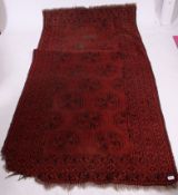 An antique indian style red and black geometric patterned floor rug