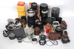 A collection of vintage mid 20th century camera lenses, light meters, filters,