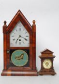 A 19th century walnut cased American gingerbread clock with glass facia and butterfly painted glass.