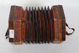 A vintage wooden squeeze box accordion instrument with central bellows and push buttons to both