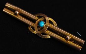 A 9ct bar brooch with twin bars interlinking C - Chanel style letterring turquoise central stone.