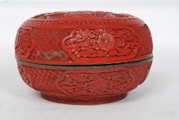 A believed 19th century Chinese large circular cinnabar lacquered box and cover.