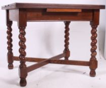 An early to mid 20th century oak barley twist dining table being united by cross stretchers,