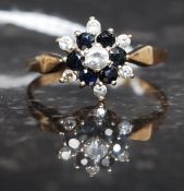 A 9ct gold, diamond and sapphire flower head ring.