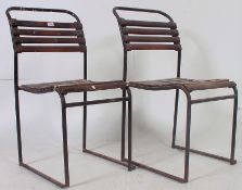 A pair of retro 1970's wooden slatted stacking village hall - workers chairs with shabby chic