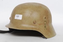 A later WW2 German Helmet M35 Heer helmet with German decals and Afrikacops decal.
