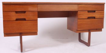 A vintage 1960's Uniflex retro teak wood writing table desk raised on angular supports with series