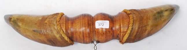 A pair of vintage taxidermy ox horns set to a central wooden turned mount.