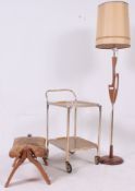 A collection of furniture to include a standard lamp, retro serving trolley, camel stool etc.
