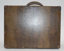 A vintage 1920's Decca portable gramaphone in faux crocodile skin suitcase.