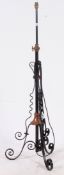 An early 20th century rococo metal and copper standard lamp having scrolled base,