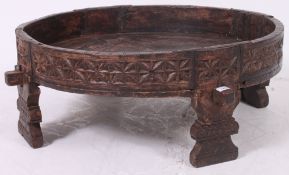 An early 20th century Indian - oriental opium cartwheel table - coffee table stool of rustic form