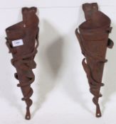 An unusual pair of hand crafted cast iron wall sconces of heavy form by Strawberry Steel.