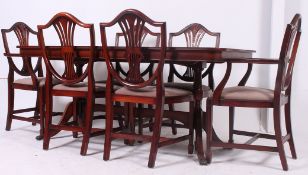 A Regency style mahogany inlaid dining room suite to include 6 wheatsheaf dining chairs and a