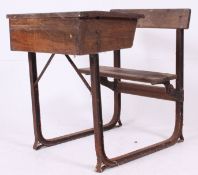 A vintage early 20th century cast iron and oak school desk.