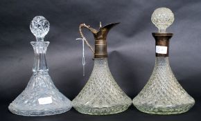 An early 20th century cut glass ships decanter together with a ships claret decanter and another.
