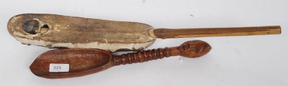An African wooden carved hardwood spoon with anthropomorphic handle together with a skin covered