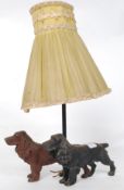 An unusual mid 20th century table lamp adorned with cast metal spaniels with central stem and shade