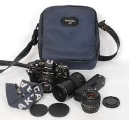 A Cased Praktica vintage 35 mm camera along with lenses to include an F 28 lens