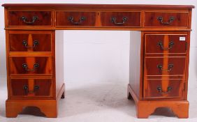 An Antique Georgian style yew wood twin pedestal desk.