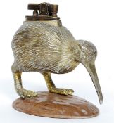 A 1950's Japanese gilt metal table top cigarette lighter in the form of a Kiwi raised over carved