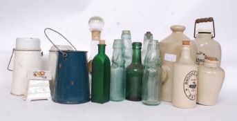 A collection of stoneware and glass  advertising bottles with many local examples along with enamel