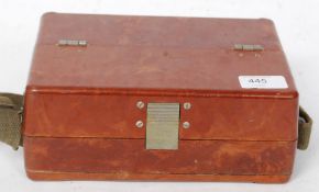 A believed military issue field telephone set in protective case with carry strap.