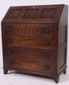 A Jaycee oak bureau - writing table desk having carved panel fall front bureau with appointed