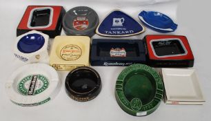 A collection of twelve vintage pub advertising ash trays to include Skol, Whitbread, Heineken,