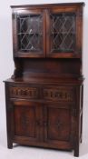 A Jaycee oak dresser cabinet sideboard having carved panel doors with drawers to the base having