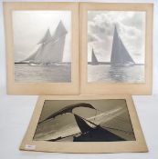 Three large photographs of sailing ships with sails down in full flight