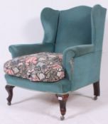 An Victorian / Edwardian wing back fireside armchair,