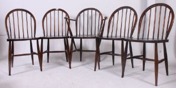 A set of 5 Ercol utility marked dining chairs having hoop back with turned rails over saddle seats