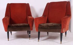 A stunning pair of 1960's Danish influence armchairs raised on turned ebonised tapering supports