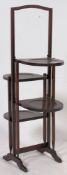A 1920's oak metamorphic 4 step folding oak cake stand having handle top and circular tiers.