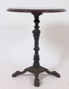 A Victorian cast iron base tavern table, with round top standing on cast iron base with four feet.