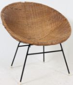 A retro vintage wicker chair on tubular metal supports.