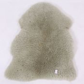 A vintage 1960's dyed green retro lambswool rug ( see illustrations) with hide to verso