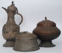 A collection of over sized Middle Eastern / Indian items to include a water ewer, lidded pots,