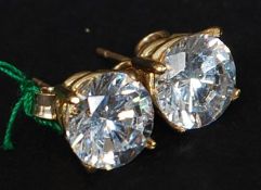 A pair of ladies 9ct gold cz stone claw mounted earrings.