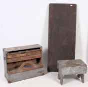 A retro ex military dispersal table together with a carpenters stool and open sectional toolbox /