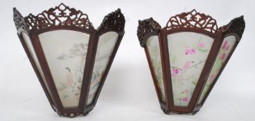 A pair of Chinese hardwood and glass ceiling lanterns. The panels with decorative scenes.