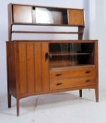 A vintage 1950's retro Lebus cabinet sideboard being raised on angled legs with cupboards and
