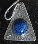 A High Art Nouveau pewter pendant in the manner of Archie Knox having an inset Ruskin style finial