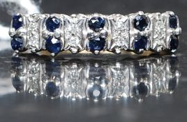A 9ct gold, diamond and sapphire channel set ring. The central stones approx 1pnts each.